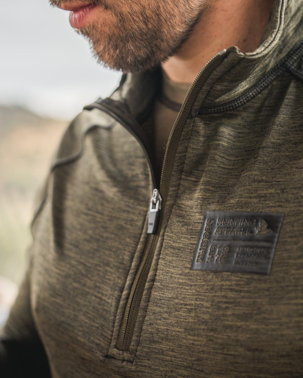 Pine Green Melange Coloured Seeland Peak Half Zip on outdoor background #colour_pine-green-melange