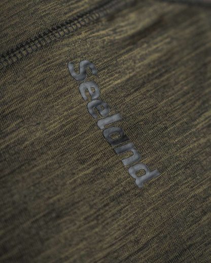 Pine Green Melange Coloured Seeland Peak Half Zip on outdoor background #colour_pine-green-melange