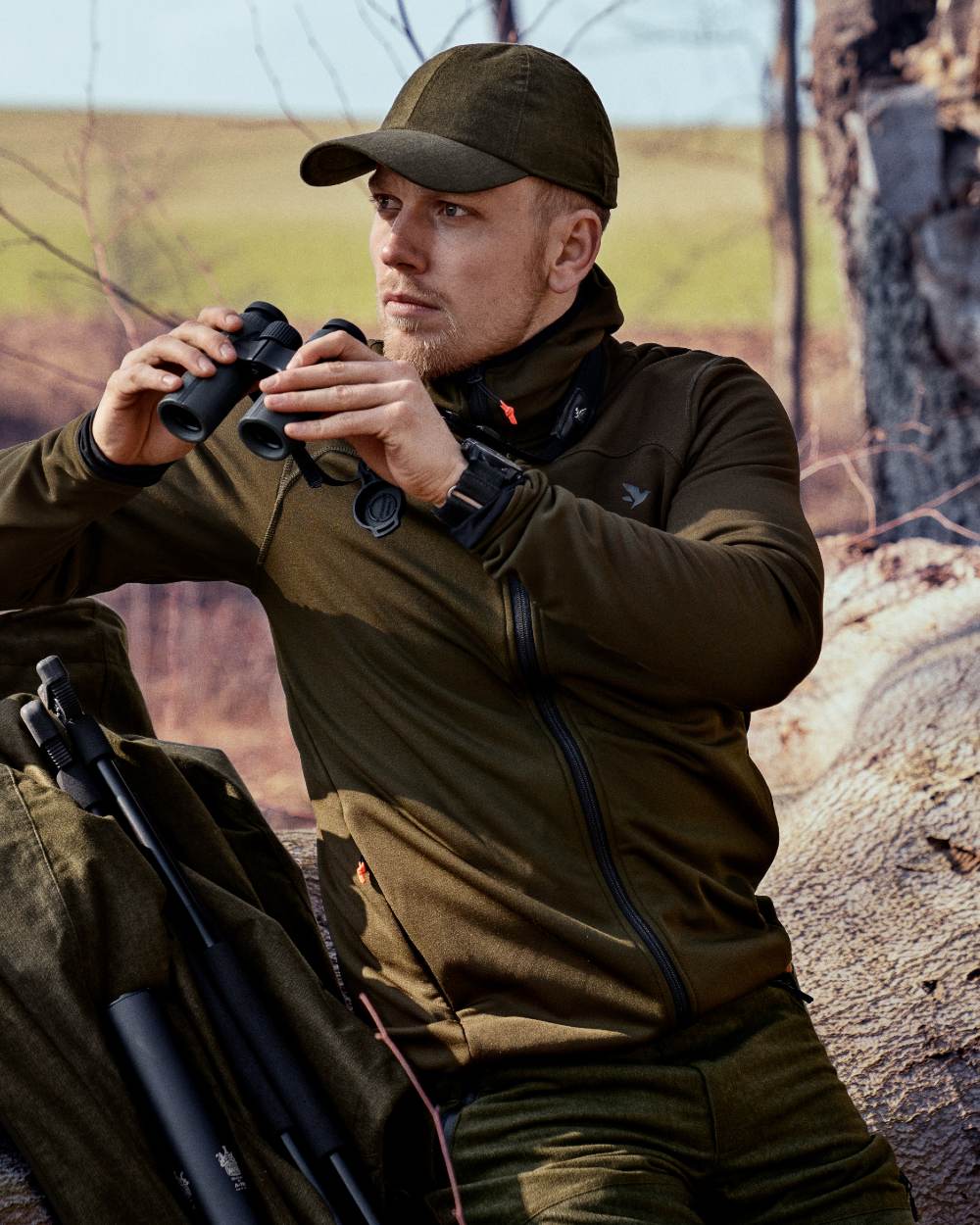 Pine Green coloured Seeland Power Fleece on forest background #colour_pine-green