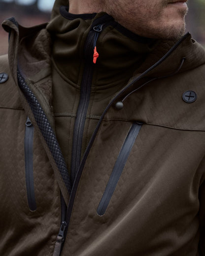 Pine Green coloured Seeland Power Fleece on forest background #colour_pine-green