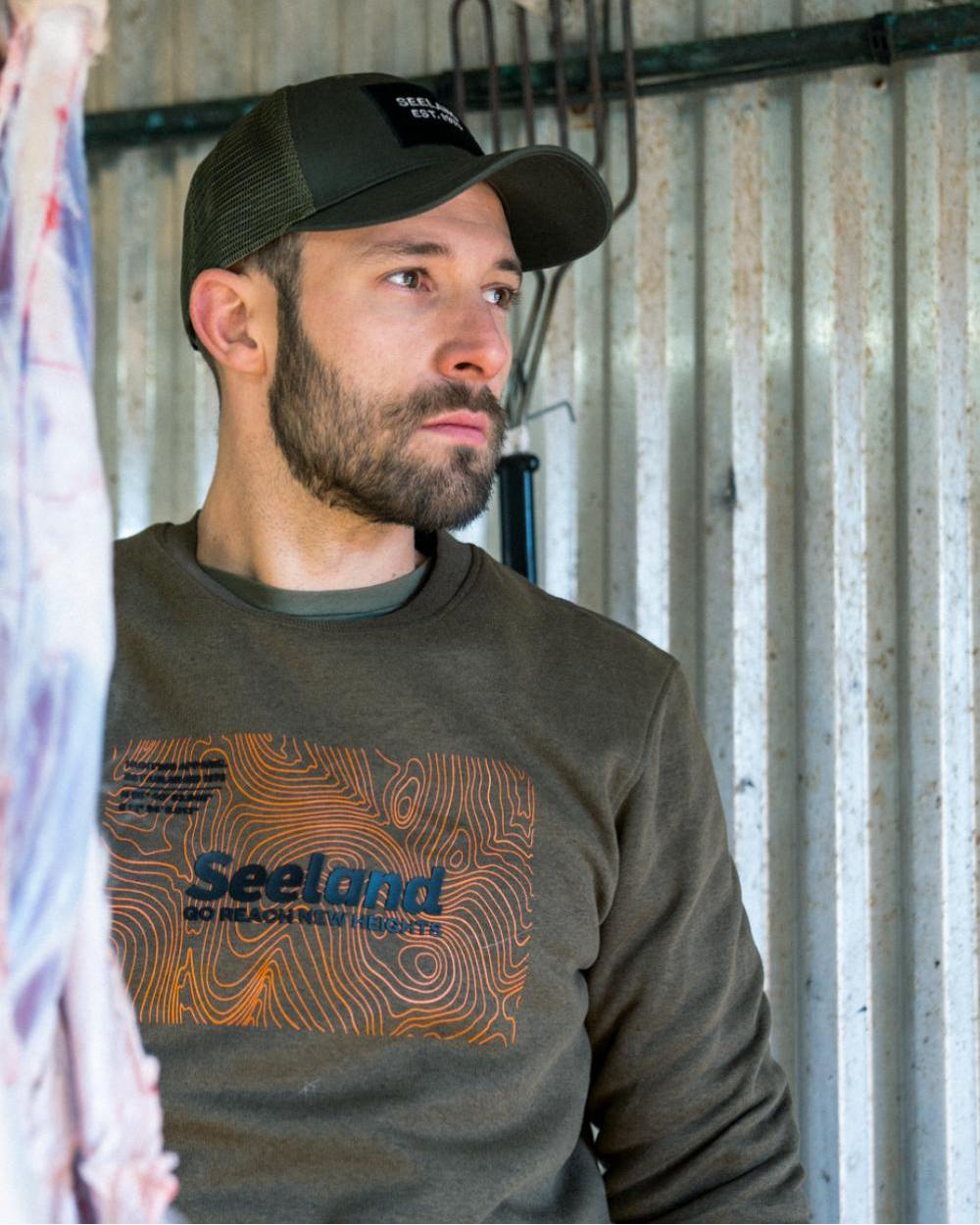 Dark Olive Melange Coloured Seeland Pulse Sweatshirt on farm background #colour_dark-olive-melange