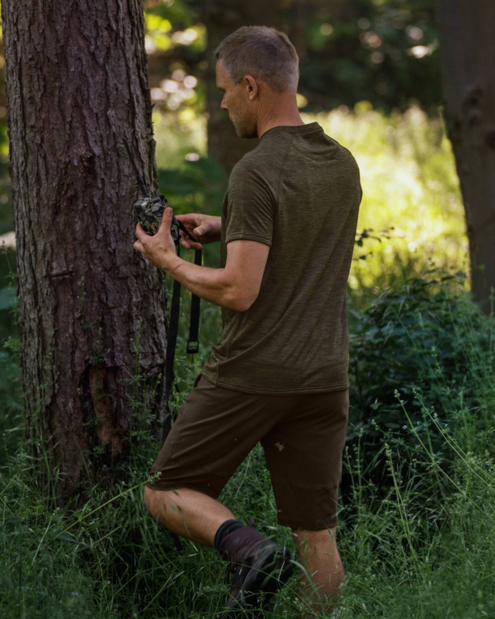 Pine Green Coloured Seeland Rowan Stretch Shorts on outdoor background #colour_pine-green