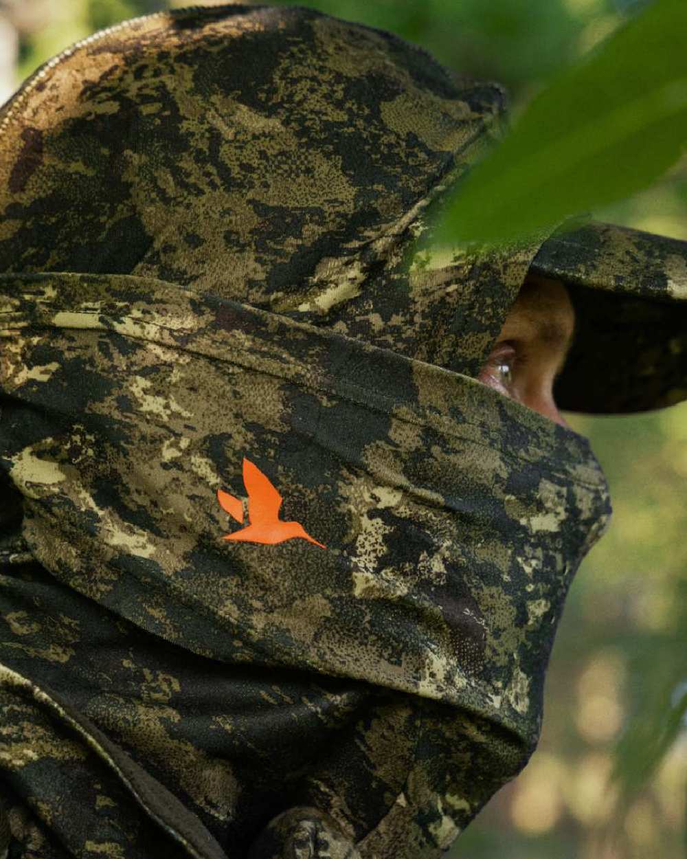 InVis Green Coloured Seeland Scent Control Camo Balaclava on forest background #colour_invis-green