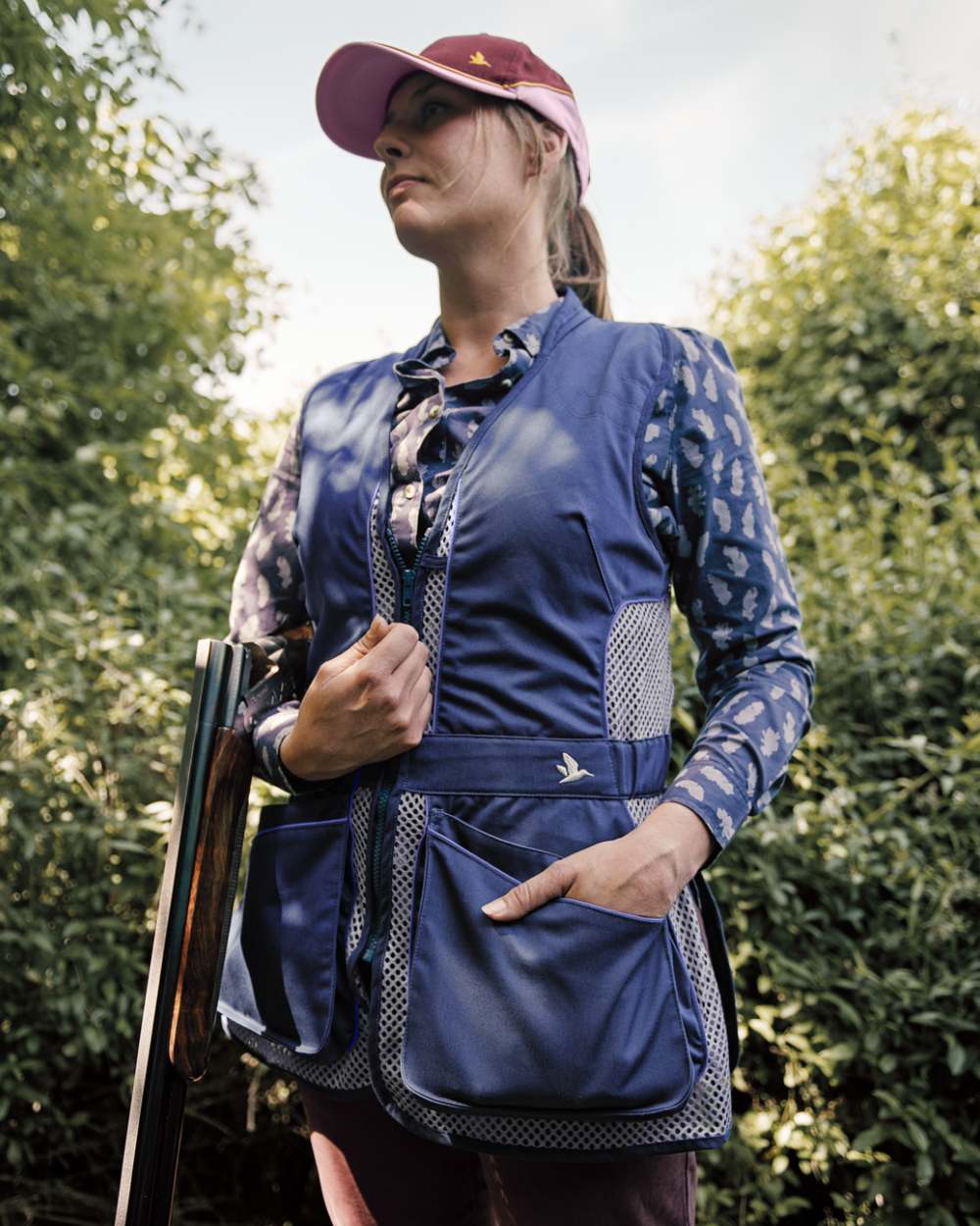 Patriot Blue Coloured Seeland Skeet II Lady Waistcoat on forest background #colour_patriot-blue