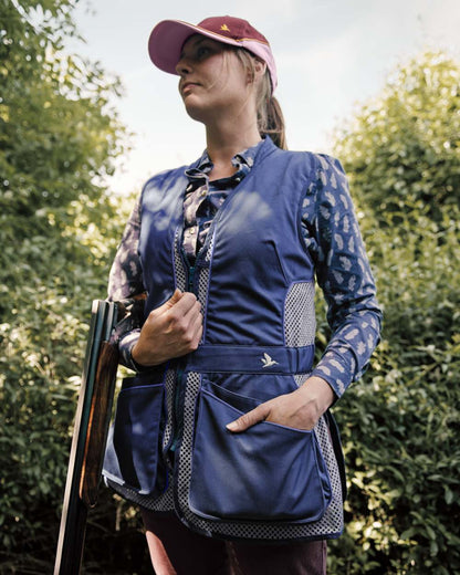 Patriot Blue Coloured Seeland Skeet II Lady Waistcoat on forest background #colour_patriot-blue