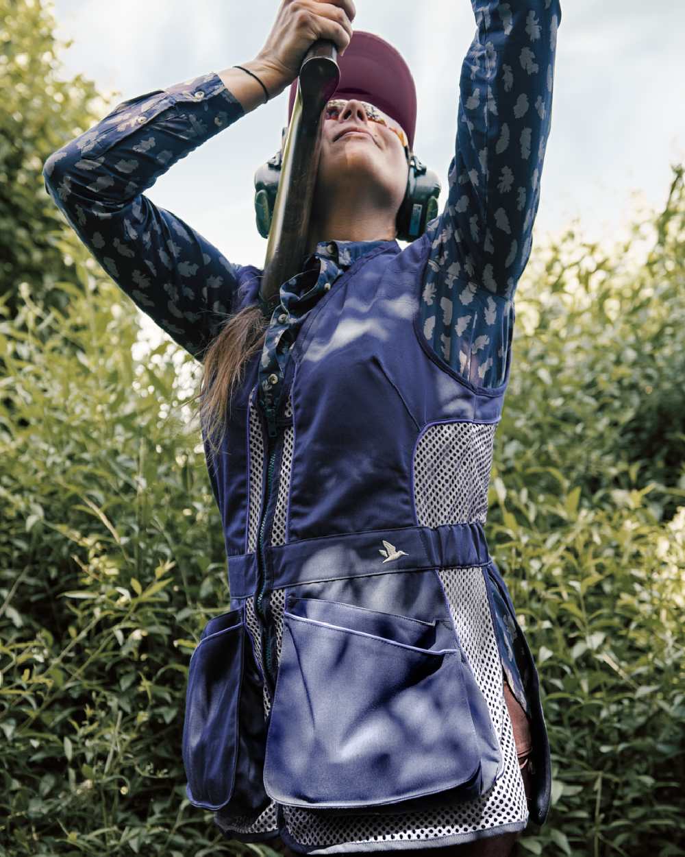 Patriot Blue Coloured Seeland Skeet II Lady Waistcoat on forest background #colour_patriot-blue