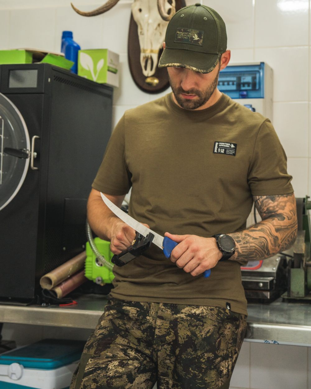 Military Olive Coloured Seeland Striker T-Shirt on indoor background #colour_military-olive