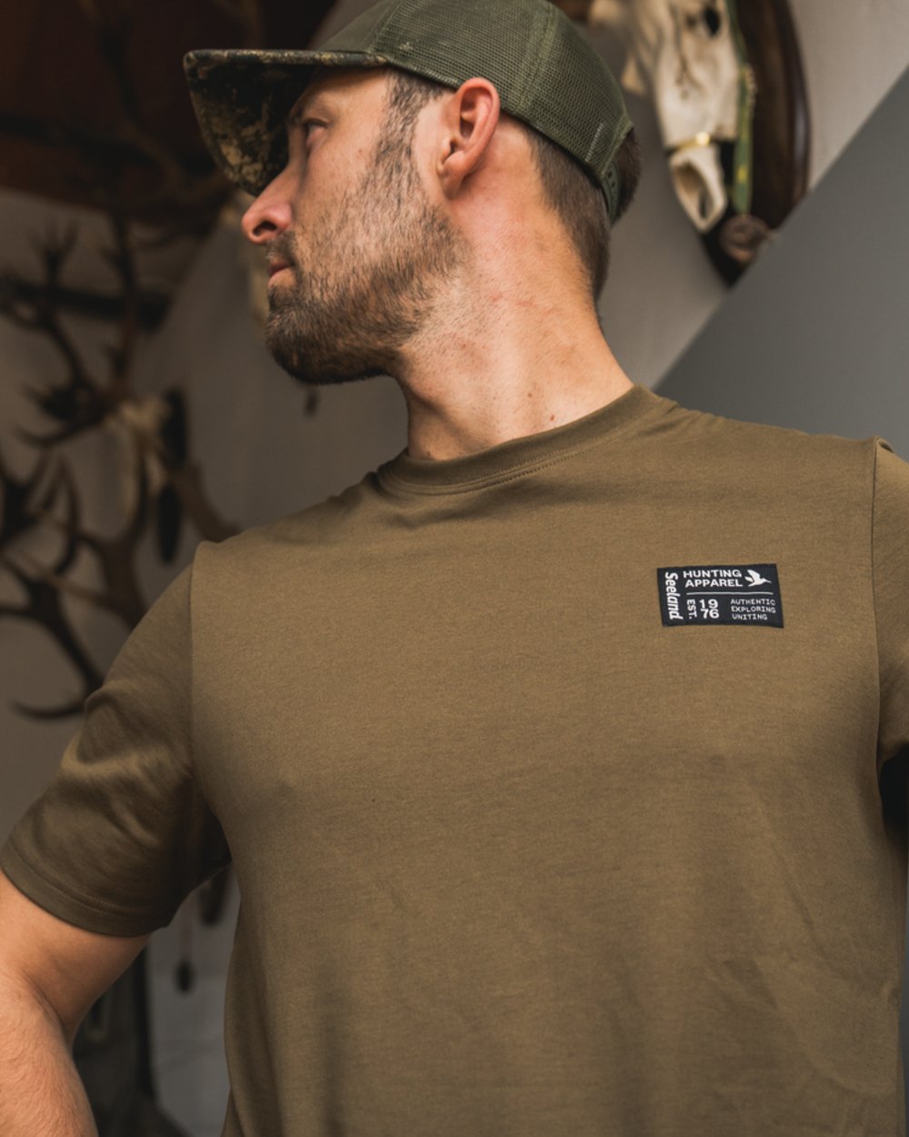 Military Olive Coloured Seeland Striker T-Shirt on indoor background #colour_military-olive