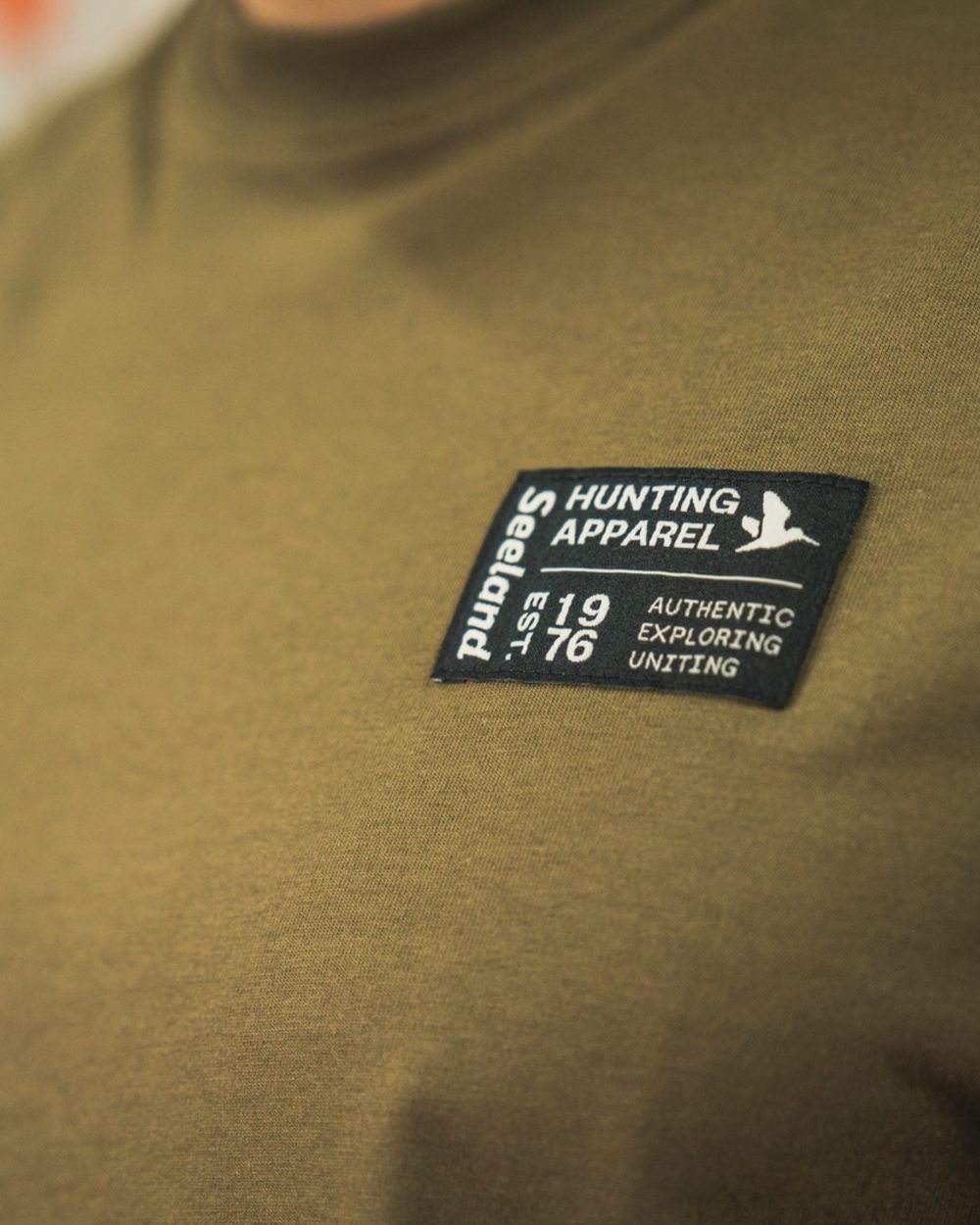 Military Olive Coloured Seeland Striker T-Shirt on indoor background #colour_military-olive