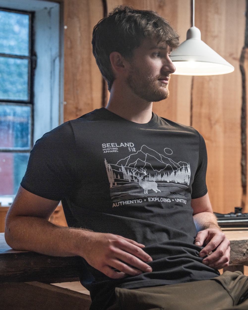 Black coloured Seeland Territory T-Shirt on outdoor background #colour_black