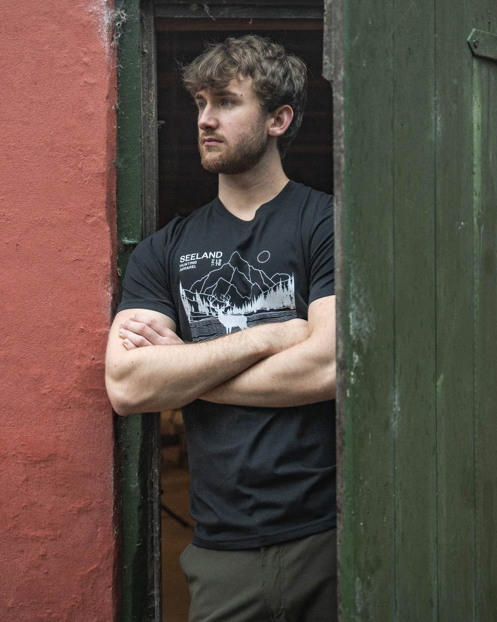 Black coloured Seeland Territory T-Shirt on outdoor background #colour_black