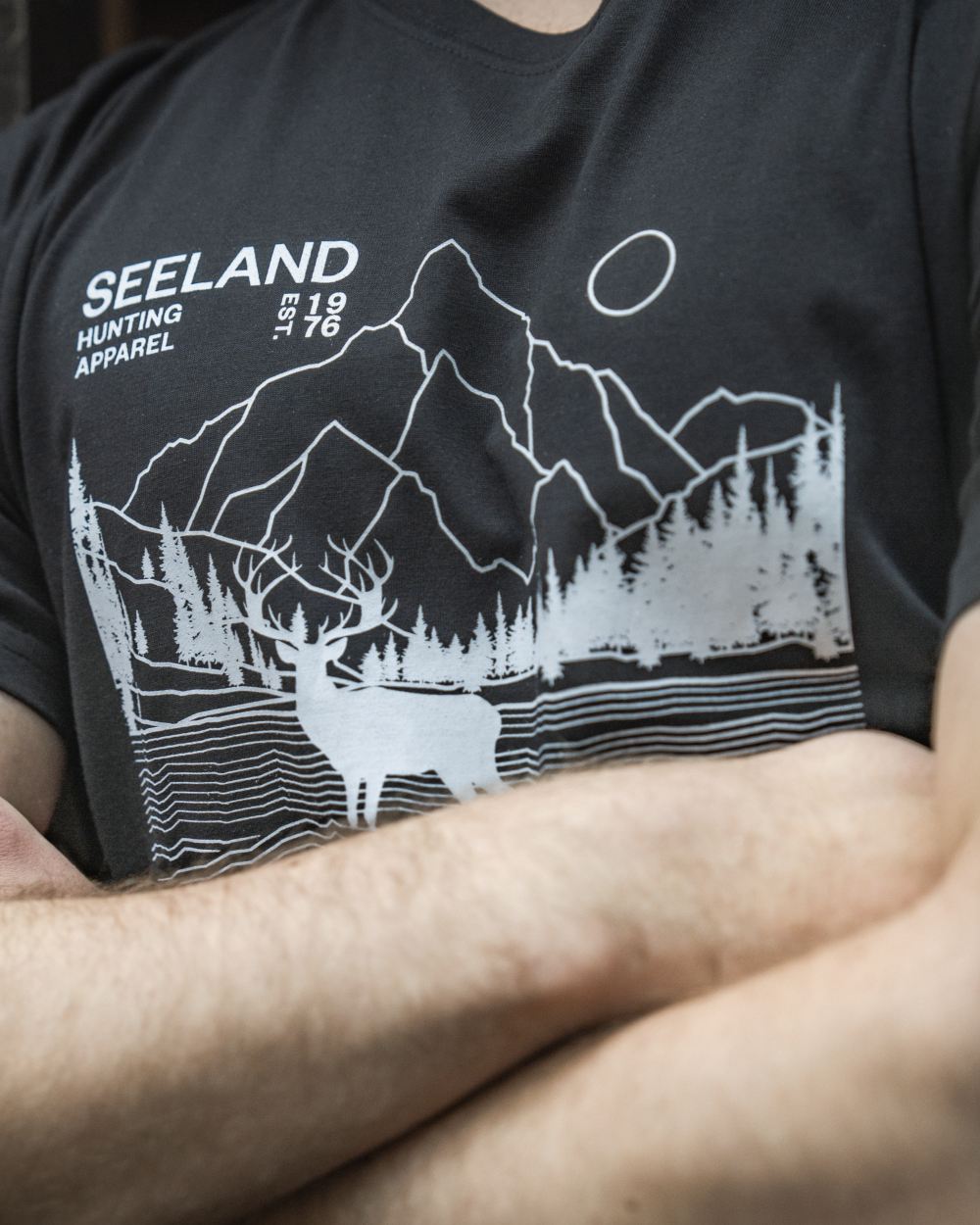 Black coloured Seeland Territory T-Shirt on outdoor background #colour_black