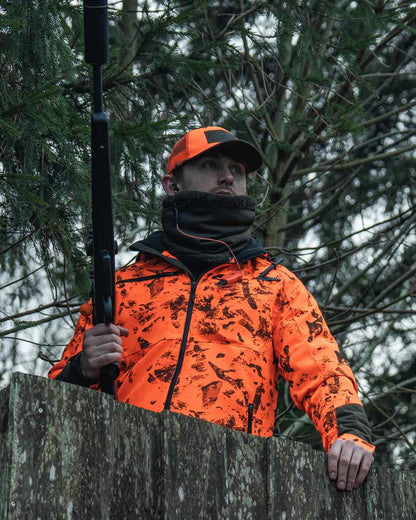 Orange Blaze InVis MPC coloured Seeland Trax Blaze Jacket on forest background #colour_orange-blaze-invis-mpc