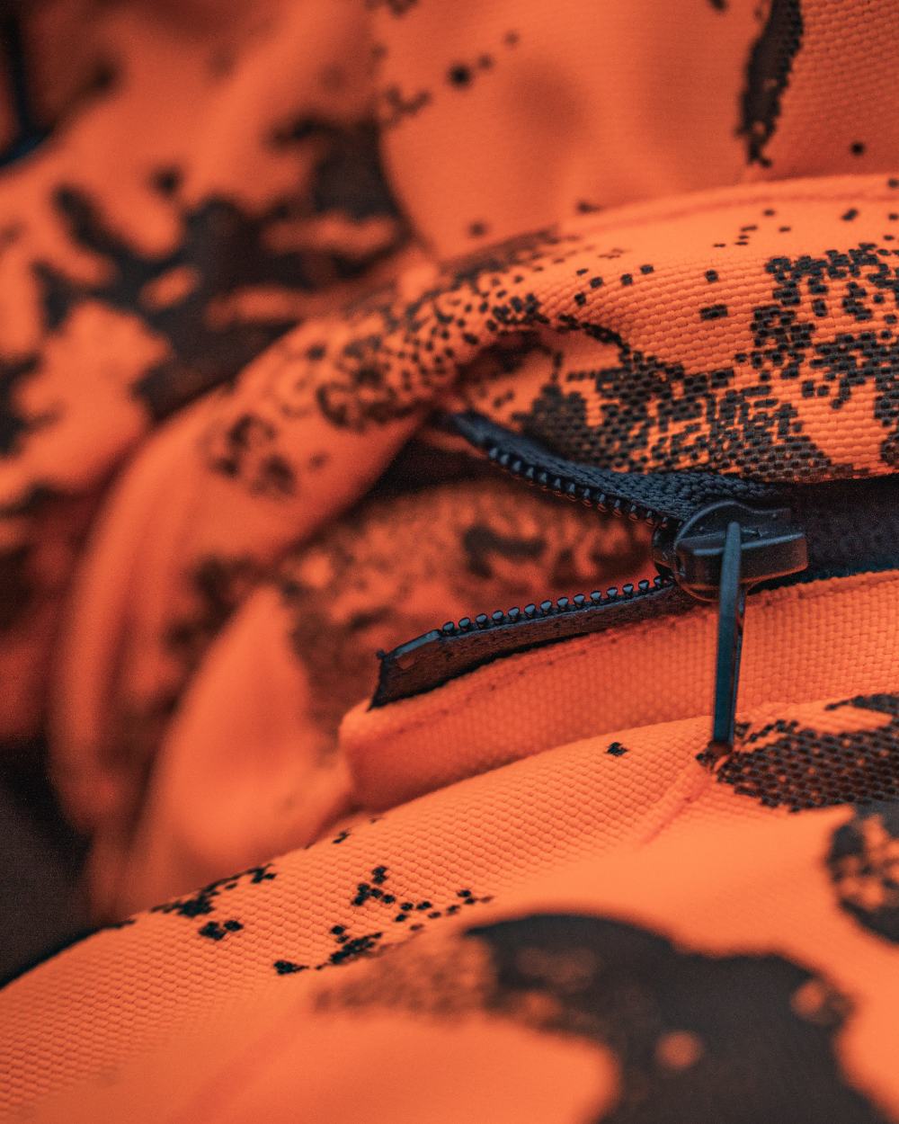 Orange Blaze InVis MPC coloured Seeland Trax Blaze Jacket on forest background #colour_orange-blaze-invis-mpc