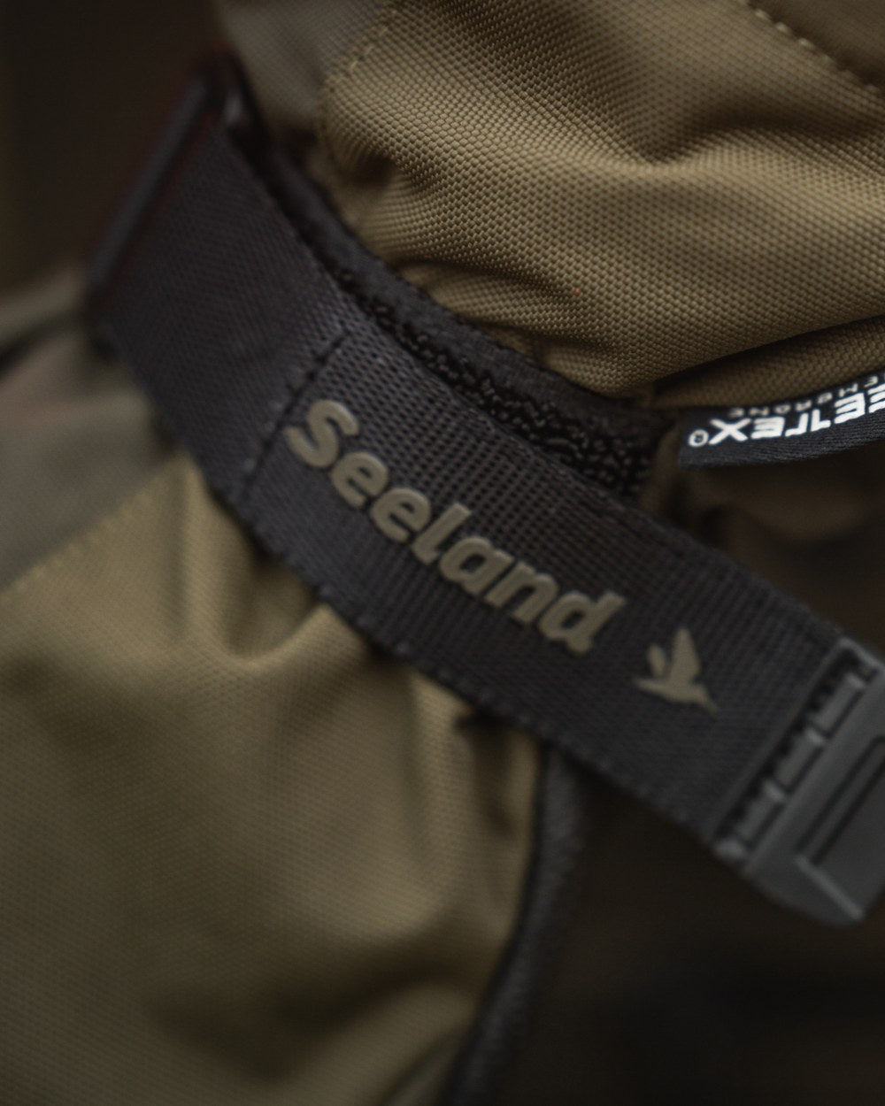 Pine Green coloured Seeland Trigger Fold-Back Gloves on forest background #colour_pine-green