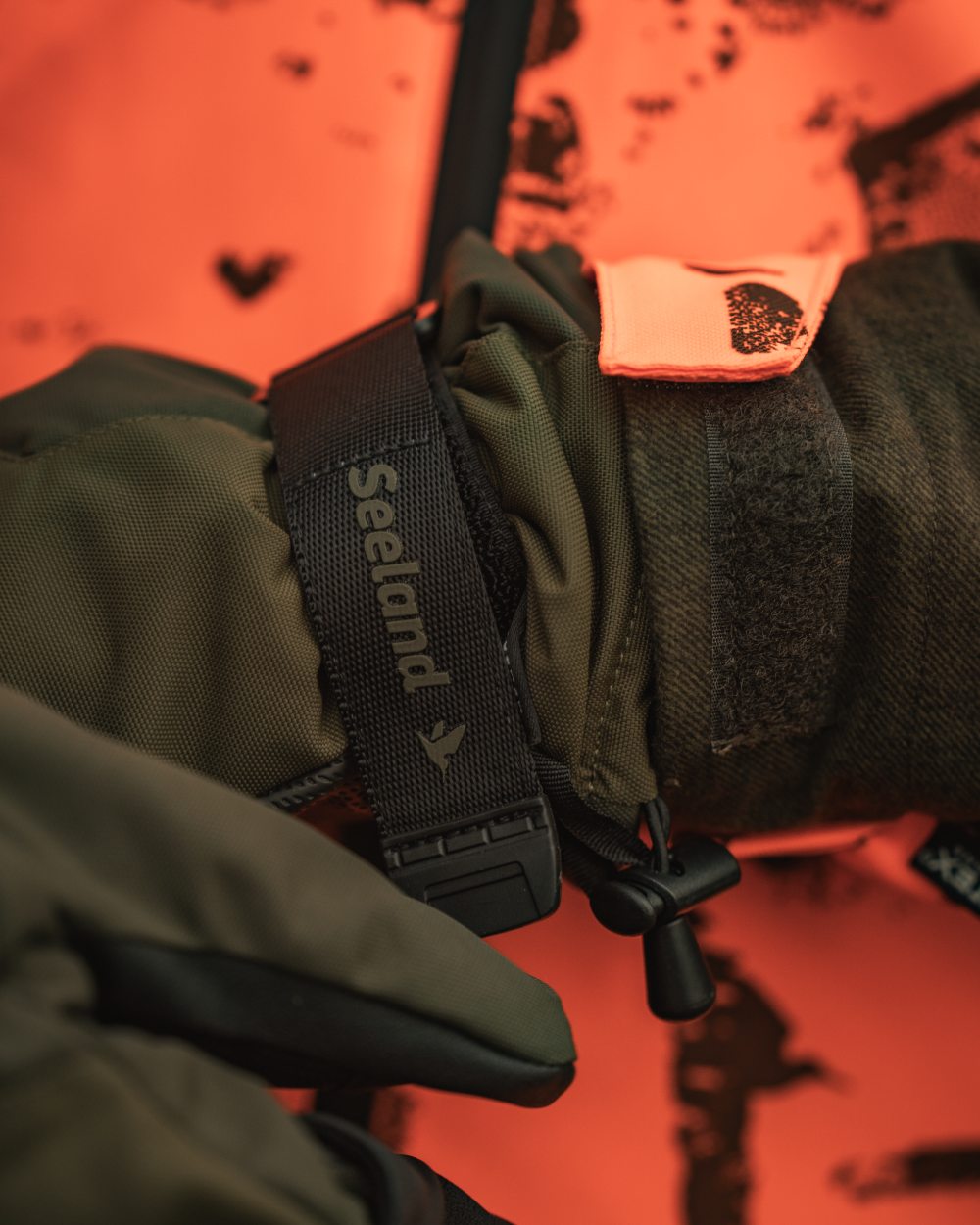 Pine Green coloured Seeland Trigger Fold-Back Gloves on forest background #colour_pine-green