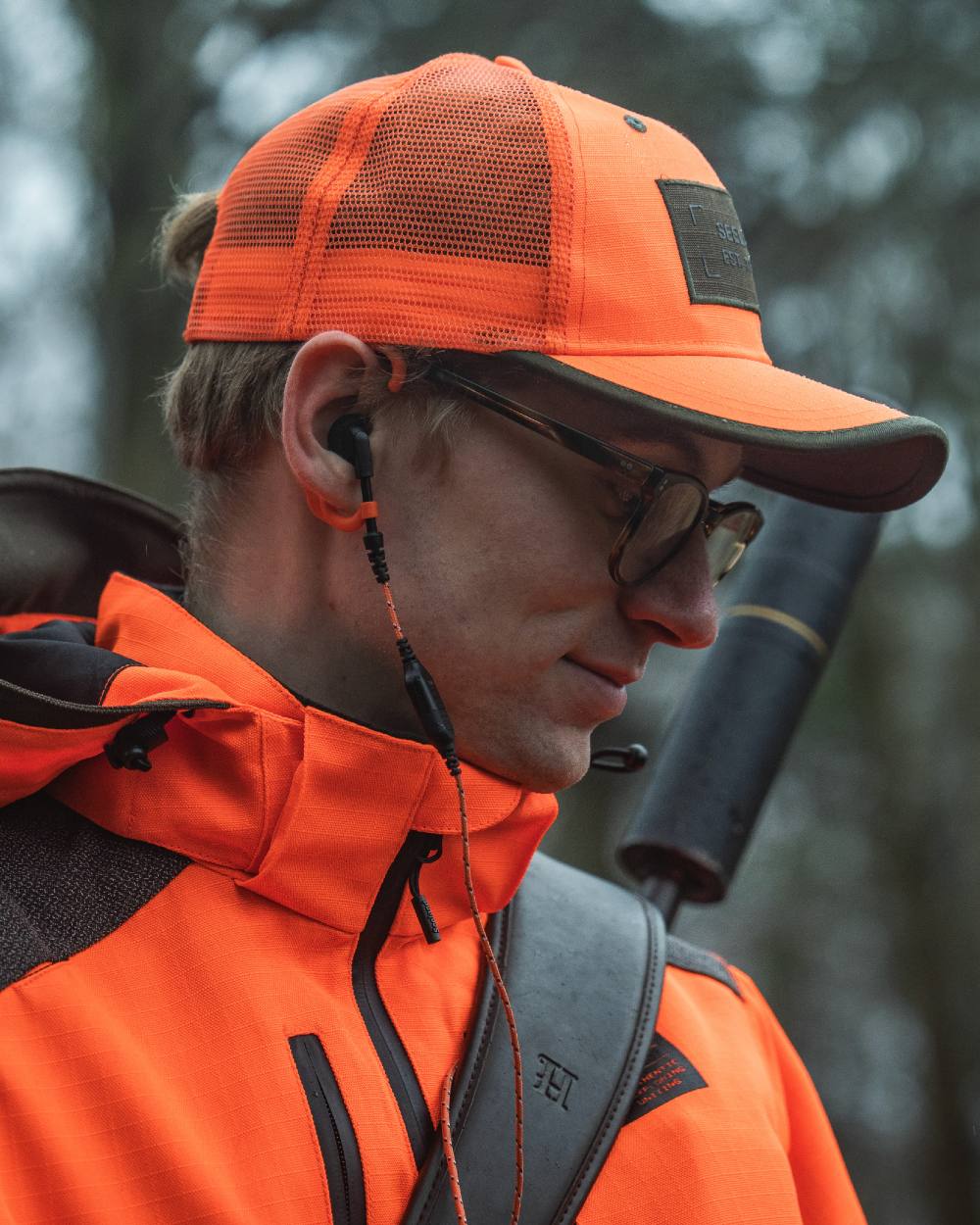 Orange Blaze coloured Seeland Venture Rover Cap on forest background #colour_orange-blaze