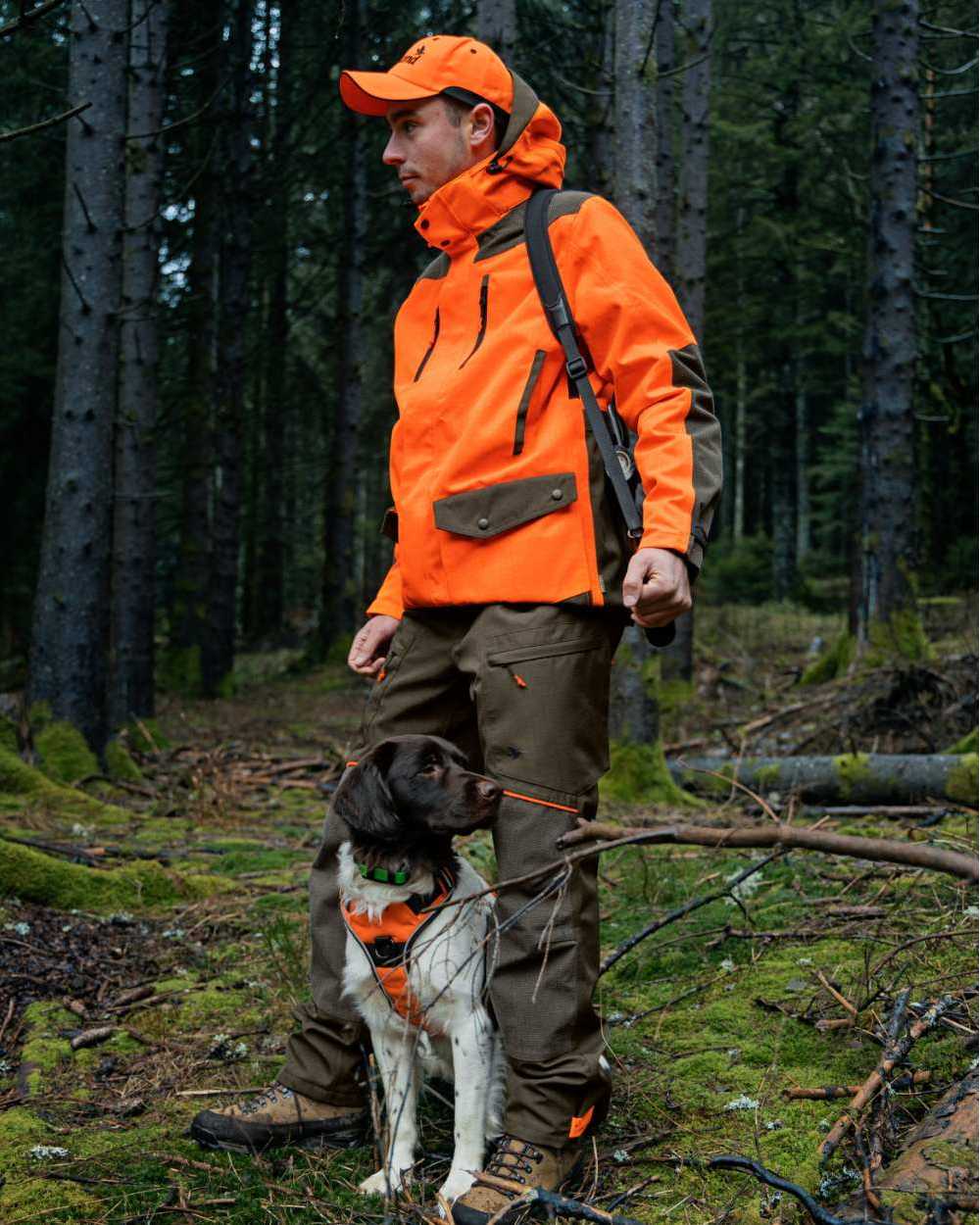 Pine Green Hi-Vis Orange Coloured Seeland Venture Rover Jacket on forest background #colour_pine-green-hi-vis-orange