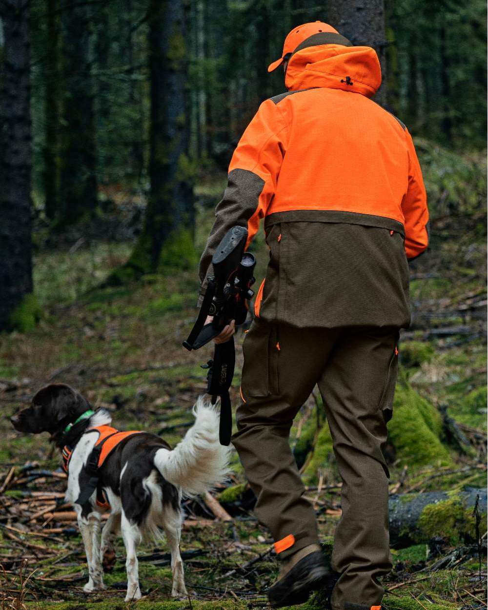 Pine Green Hi-Vis Orange Coloured Seeland Venture Rover Jacket on forest background #colour_pine-green-hi-vis-orange