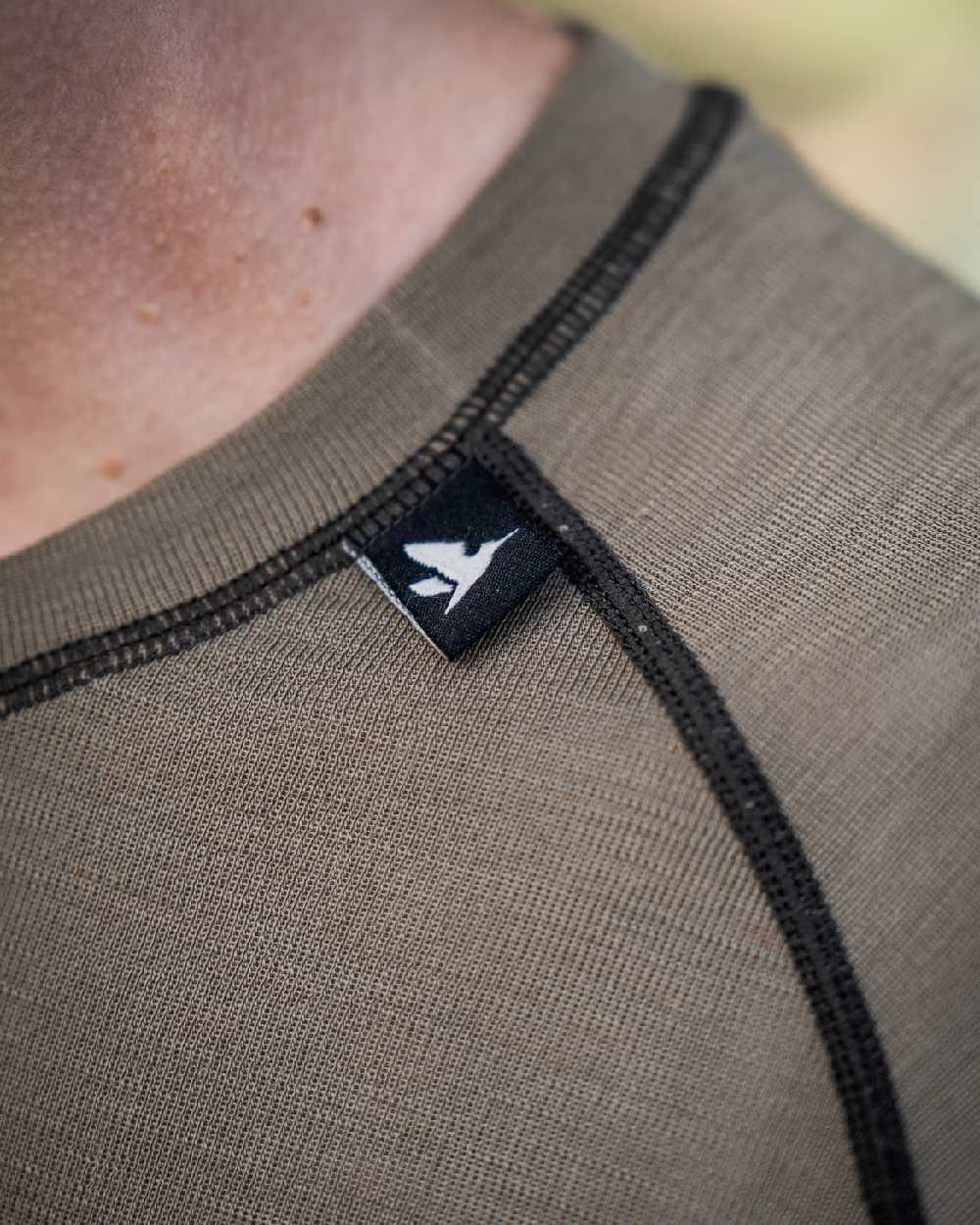 Covert Green Coloured Seeland Womens Apex Aia Merino T-shirt on outdoor background
#colour_covert-green