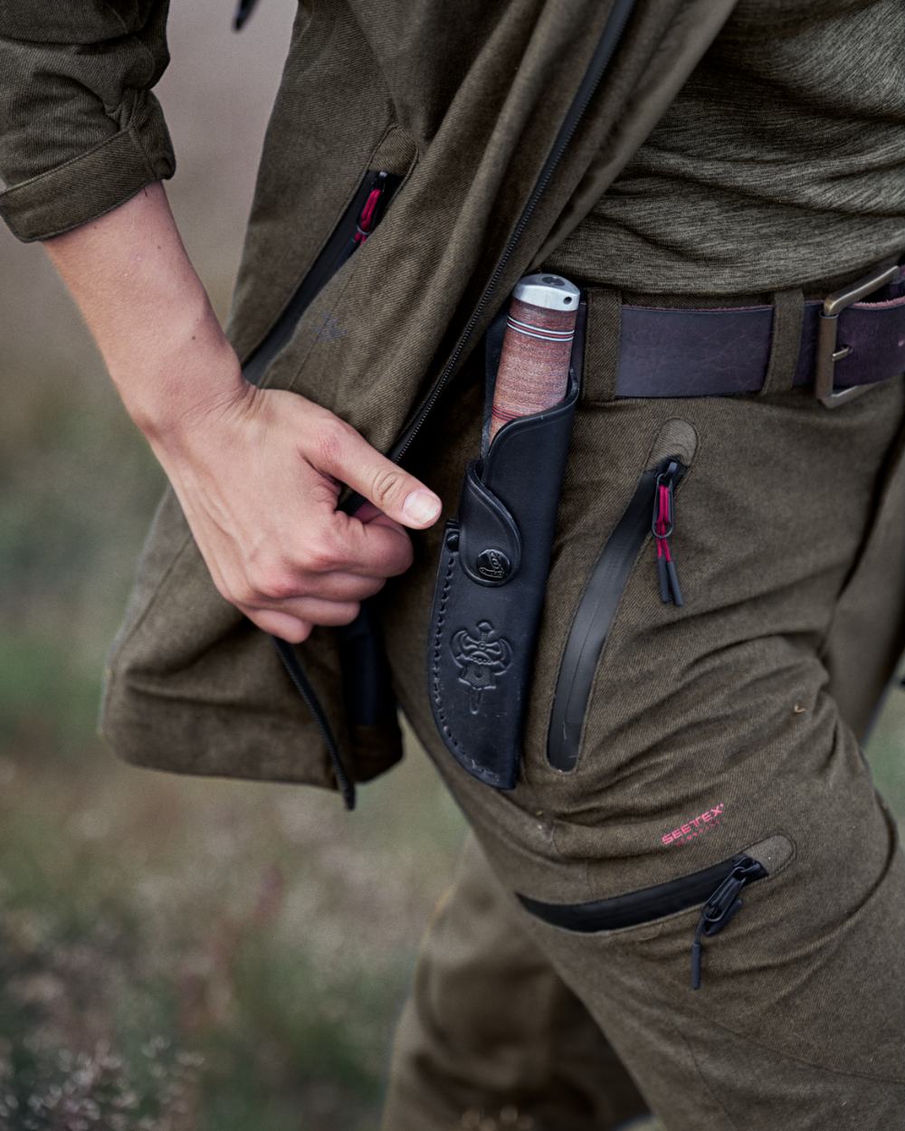 Pine Green Melange Coloured Seeland Womens Avail Trousers on forest background #colour_pine-green-melange