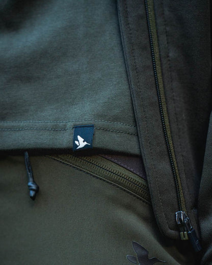 Pine Green Coloured Seeland Womens Hunting Heritage T-Shirt on forest background #colour_pine-green