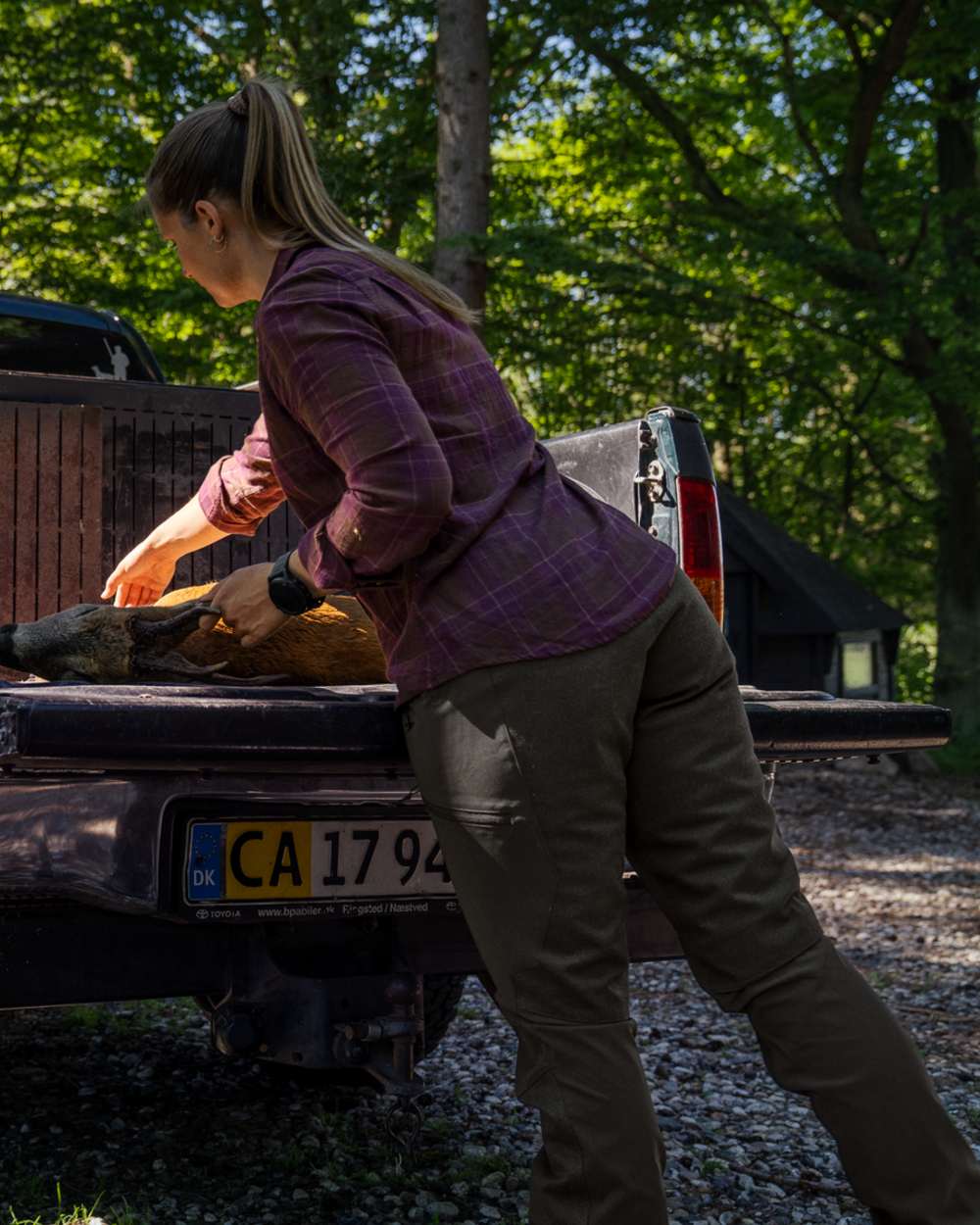 Pine Green coloured Seeland Womens Larch Membrane Trousers on forest background #colour_pine-green