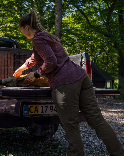 Pine Green coloured Seeland Womens Larch Membrane Trousers on forest background #colour_pine-green