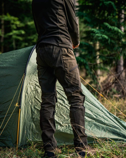 Pine Green Chocolate Torte coloured Seeland Womens Larch Stretch Trousers on forest background #colour_pine-green-chocolate-torte