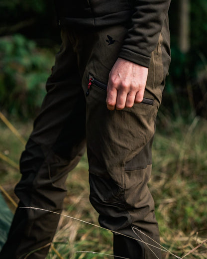 Pine Green Chocolate Torte coloured Seeland Womens Larch Stretch Trousers on forest background #colour_pine-green-chocolate-torte