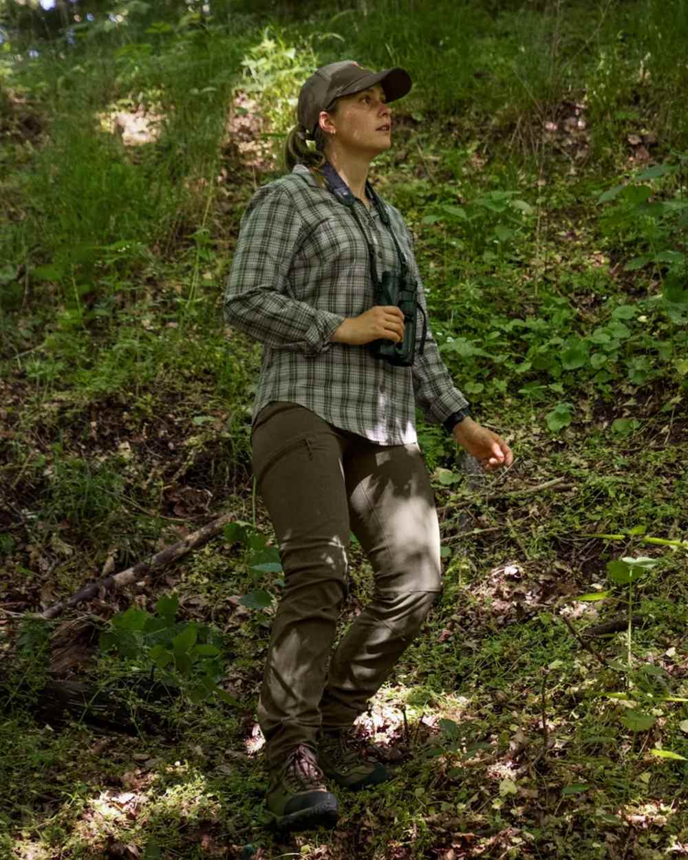 Pine Green coloured Seeland Womens Larch Stretch Trousers on forest background #colour_pine-green