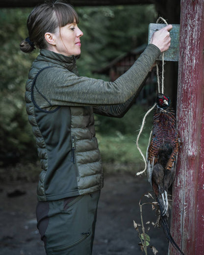 Military Olive Melange coloured Seeland Womens Peak Aia T-Shirt on forest background #colour_military-olive-melange