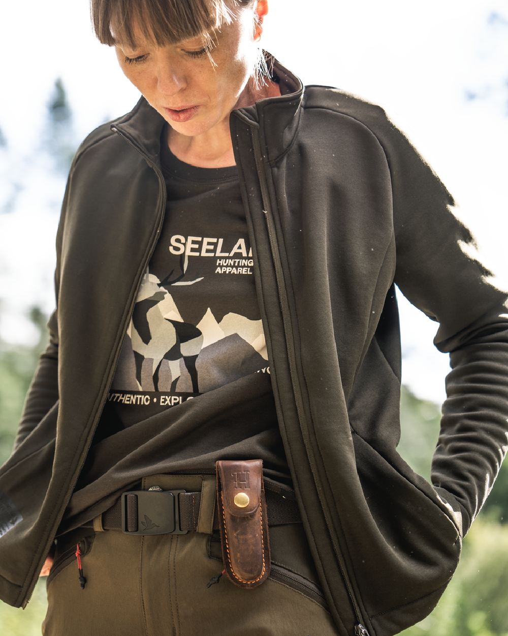 Pine Green Coloured Seeland Womens Sadie T-Shirt on blurry background #colour_pine-green