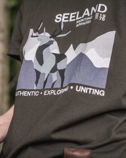 Pine Green Coloured Seeland Womens Sadie T-Shirt on blurry background #colour_pine-green