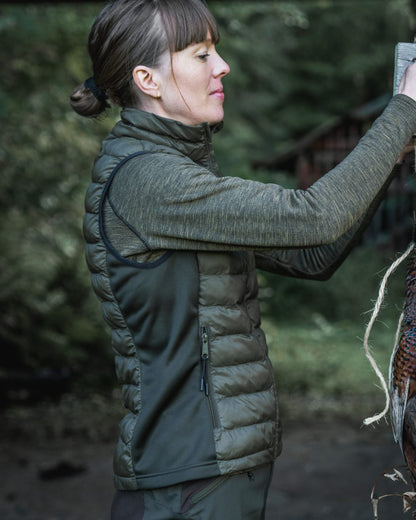 Light Pine Coloured Seeland Womens Therma Waistcoat on forest background #colour_light-pine