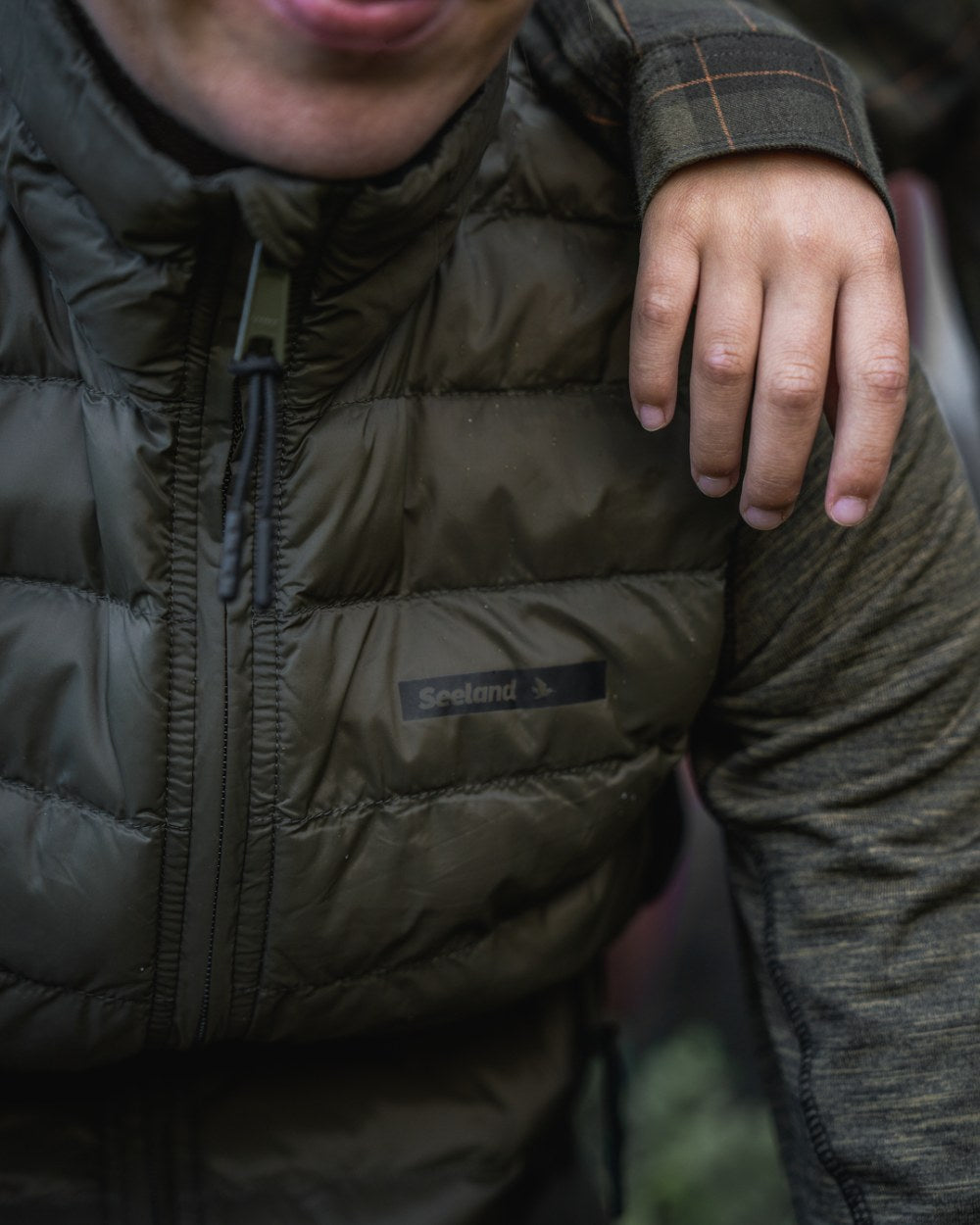 Light Pine Coloured Seeland Womens Therma Waistcoat on forest background #colour_light-pine