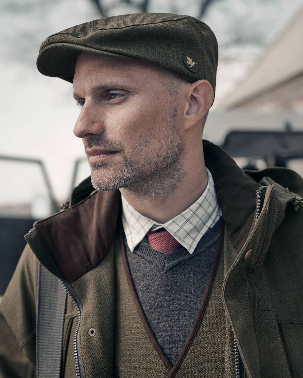 Shaded Olive coloured Seeland Woodcock Advanced Flat Cap on outdoor background #colour_shaded-olive