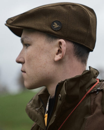 Shaded Olive coloured Seeland Woodcock Advanced Flat Cap on outdoor background #colour_shaded-olive