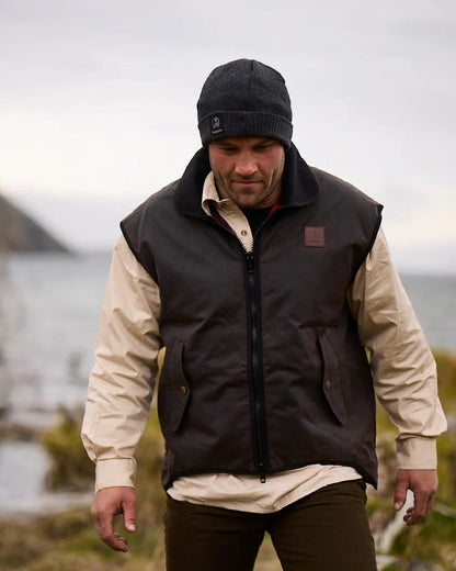 Brown Coloured Swanndri Mens Foxton Oilskin Vest with Wool Lining on blurry background #colour_brown