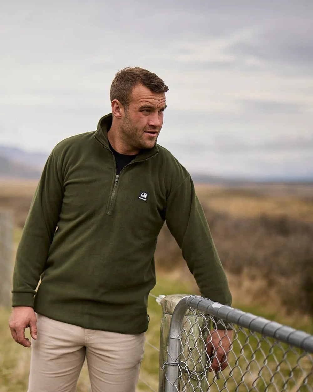 Olive Coloured Swanndri Mens Motu Fleece Pullover on forest background #colour_olive