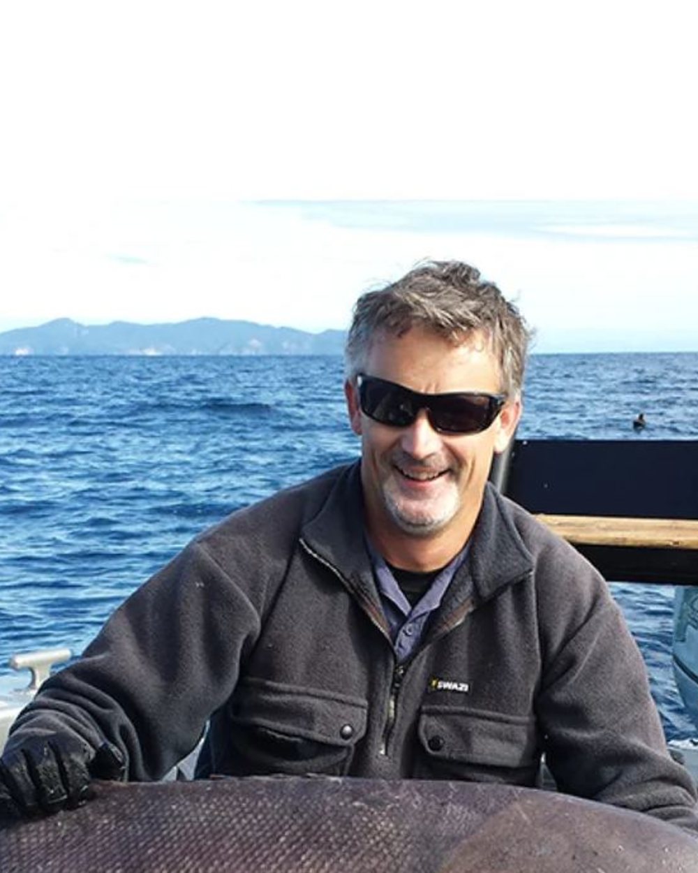 Black Coloured Swazi Back 40 Shirt on sea background #colour_black