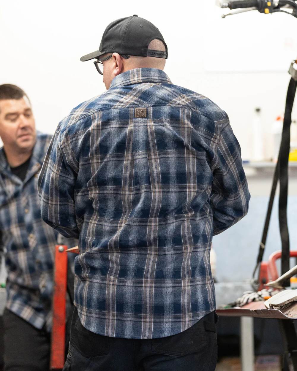 Navy coloured Swazi Grafter Shirt on blurry background #colour_navy