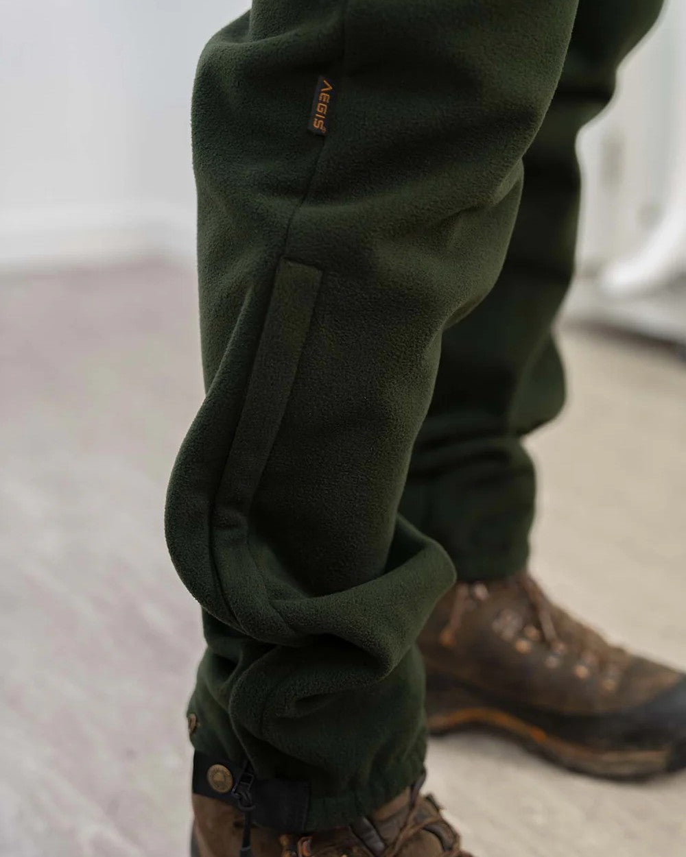 Olive Swazi Mens 4Wd Pants on floor background #colour_olive