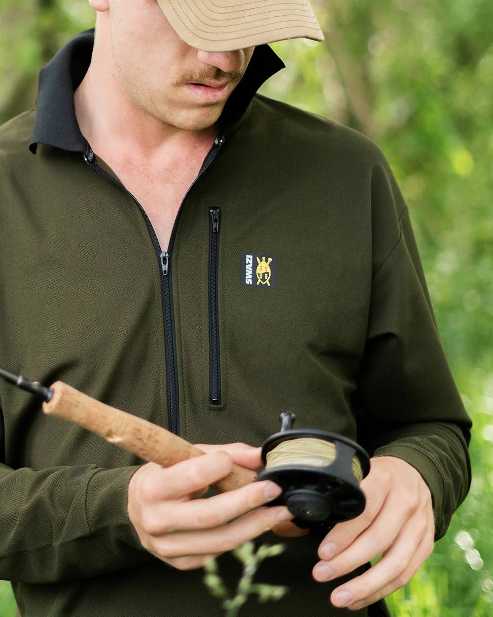 Olive coloured Swazi Mens Climb Max Long Sleeve Polo Shirt on leafy background #colour_olive