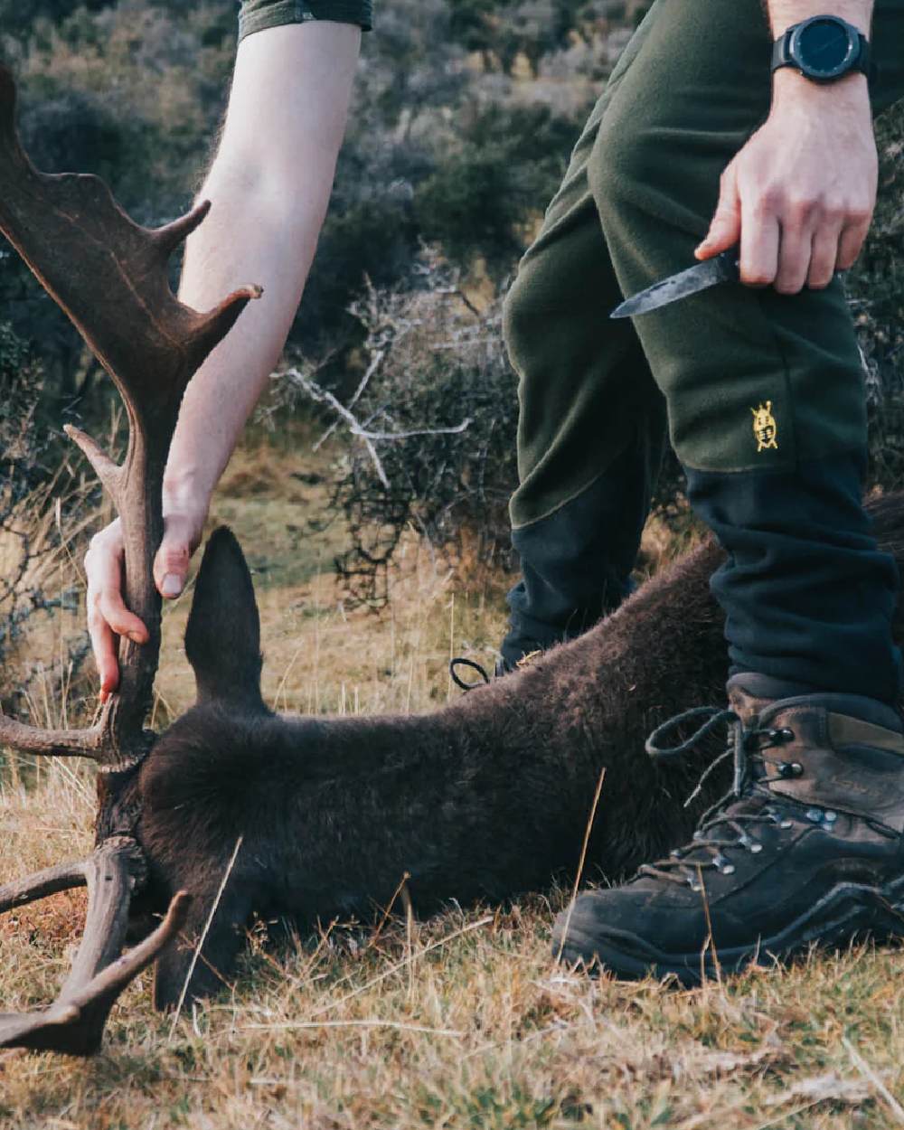 Olive Black coloured Swazi Mens Huttie Pants on blurry background #colour_olive-black