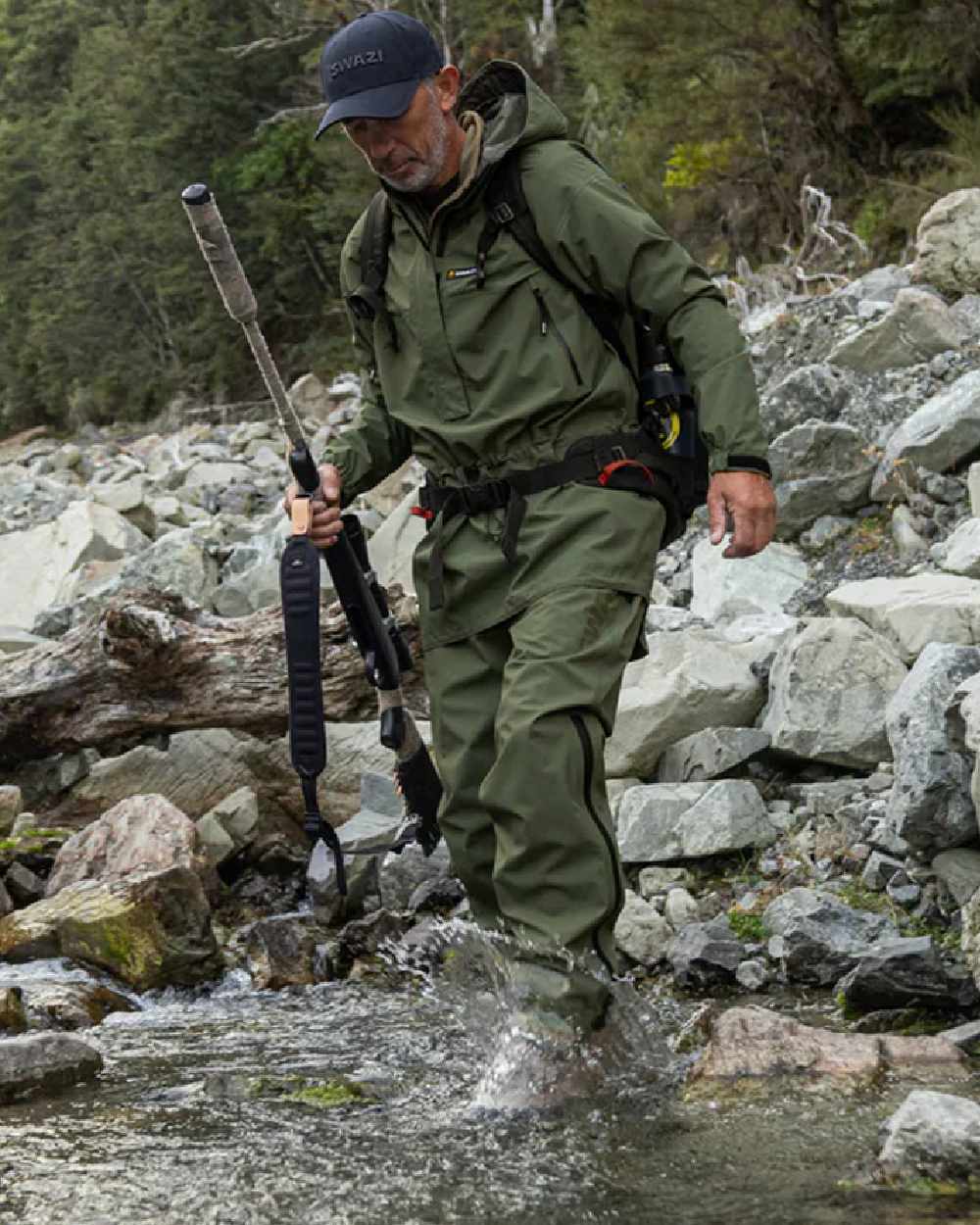 Olive coloured Swazi Mens Rifleman Ultralite Overpants on rock background #colour_olive