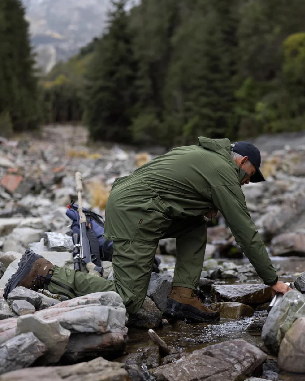 Olive coloured Swazi Mens Rifleman Ultralite Overpants on rock background #colour_olive