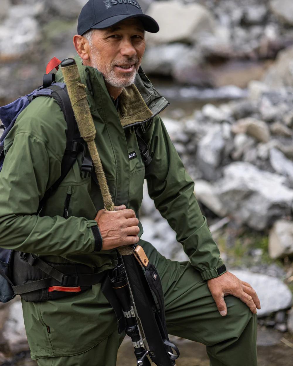 Olive coloured Mens Swazi Mens Tahr Ultralite Jacket on rock background #colour_olive