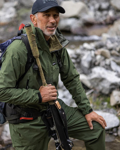 Olive coloured Mens Swazi Mens Tahr Ultralite Jacket on rock background #colour_olive