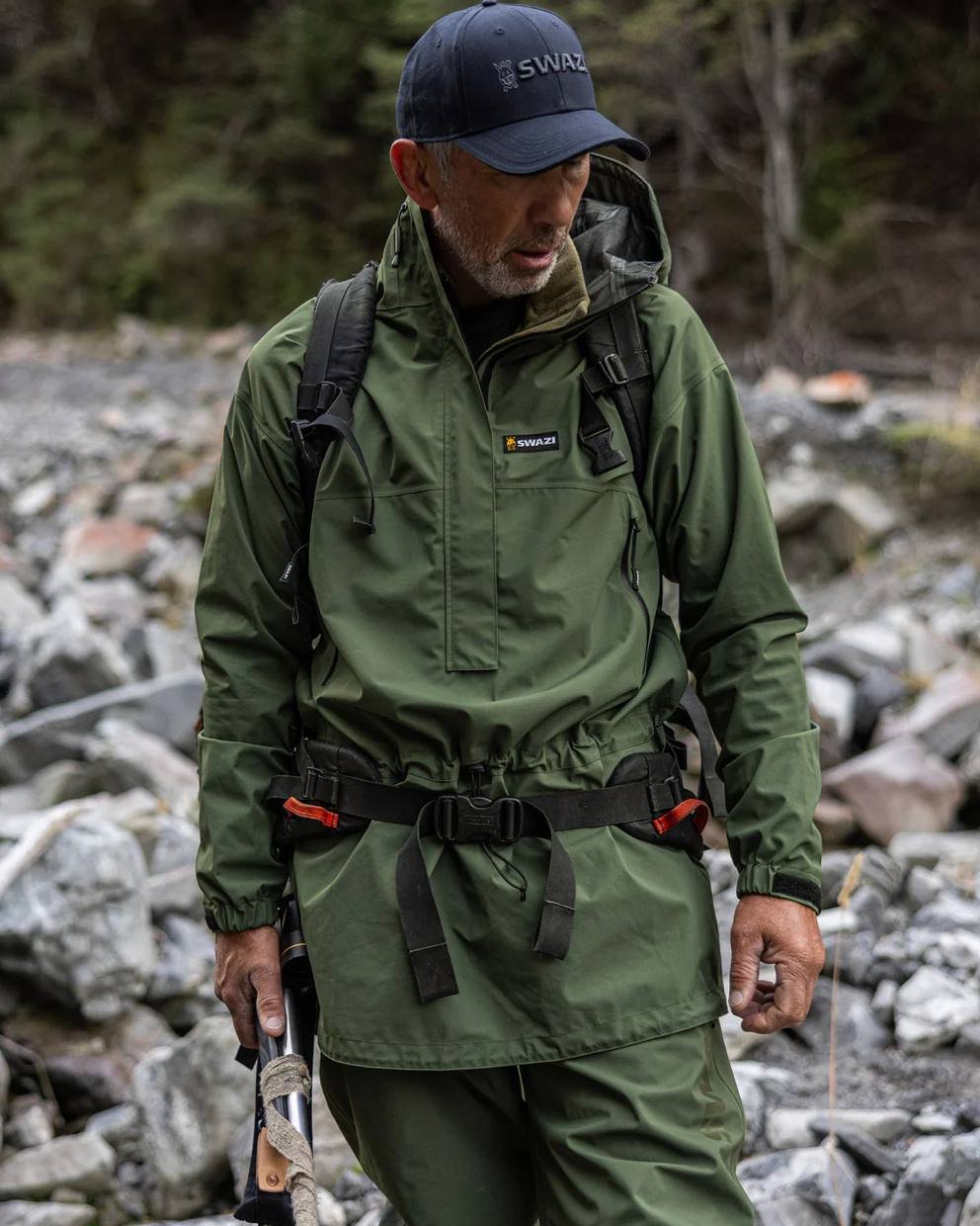 Olive coloured Mens Swazi Mens Tahr Ultralite Jacket on rock background #colour_olive